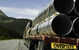 photo of flatbed truck hauling metal culverts