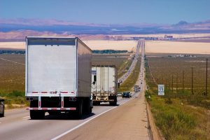 photo of semi-trucks and cars on an Interstate highway.