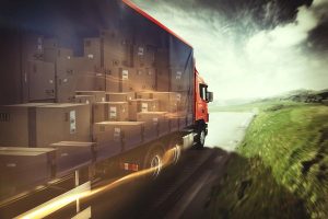 photo of truck on the road with load of boxes